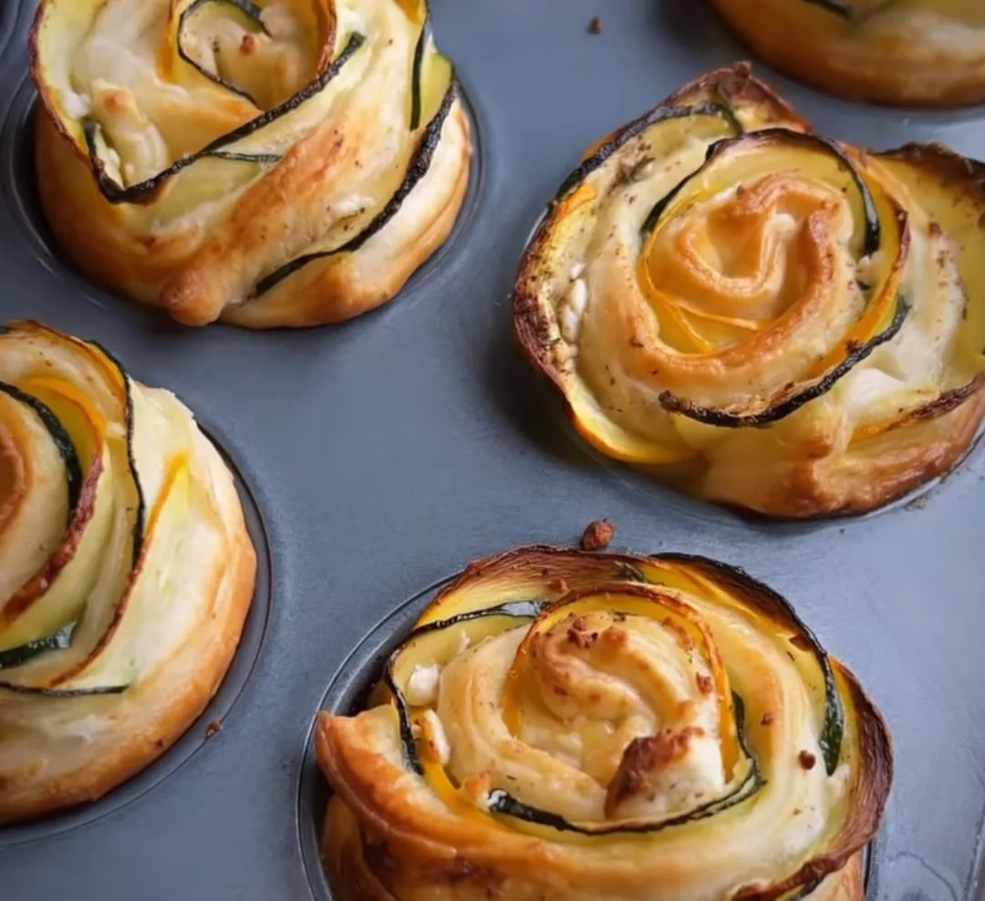Zucchini and yellow squash roses baked in puff pastry, fresh from a muffin tin.